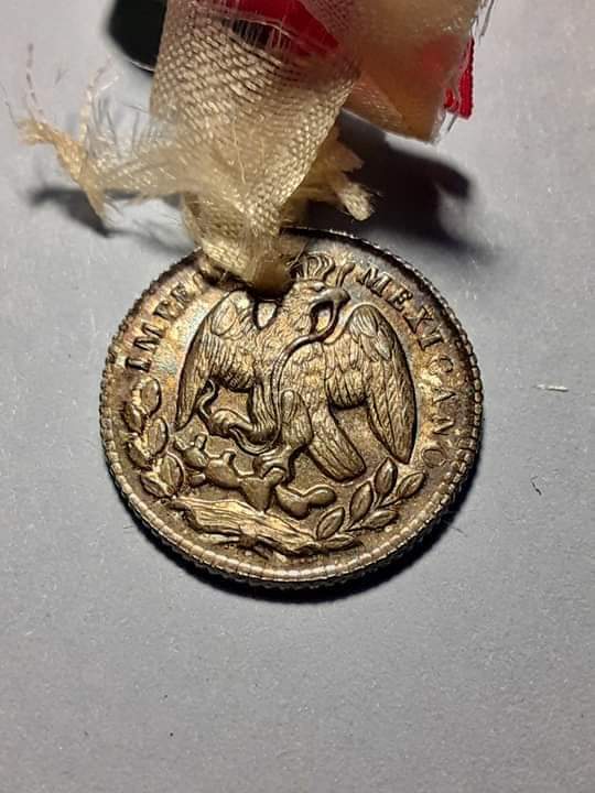 Holed-Mexican-Coin-For-A-Government-Document?