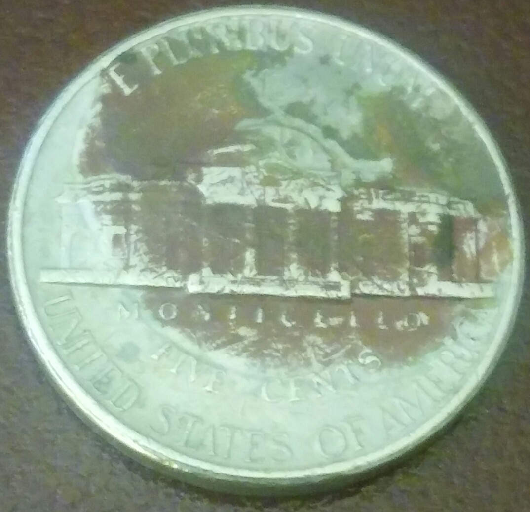 U.-S.-1996-Five-Cents.-Looks-Like-A-Sword-Is-Entering-At-Top-Of-Jefferson's
