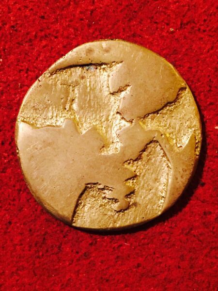 Elephant-Or-Dinosaur-Coin-With-Outline-Of-Earth?