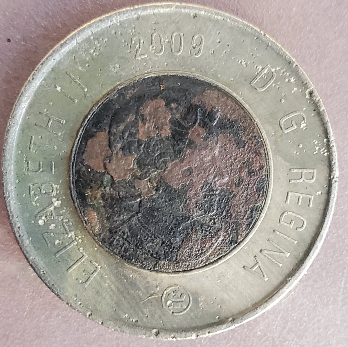 Canadian-Toonie-Planchet-Error?-Or-What?-Someone-Hurt-It?-Or-From-Mint?