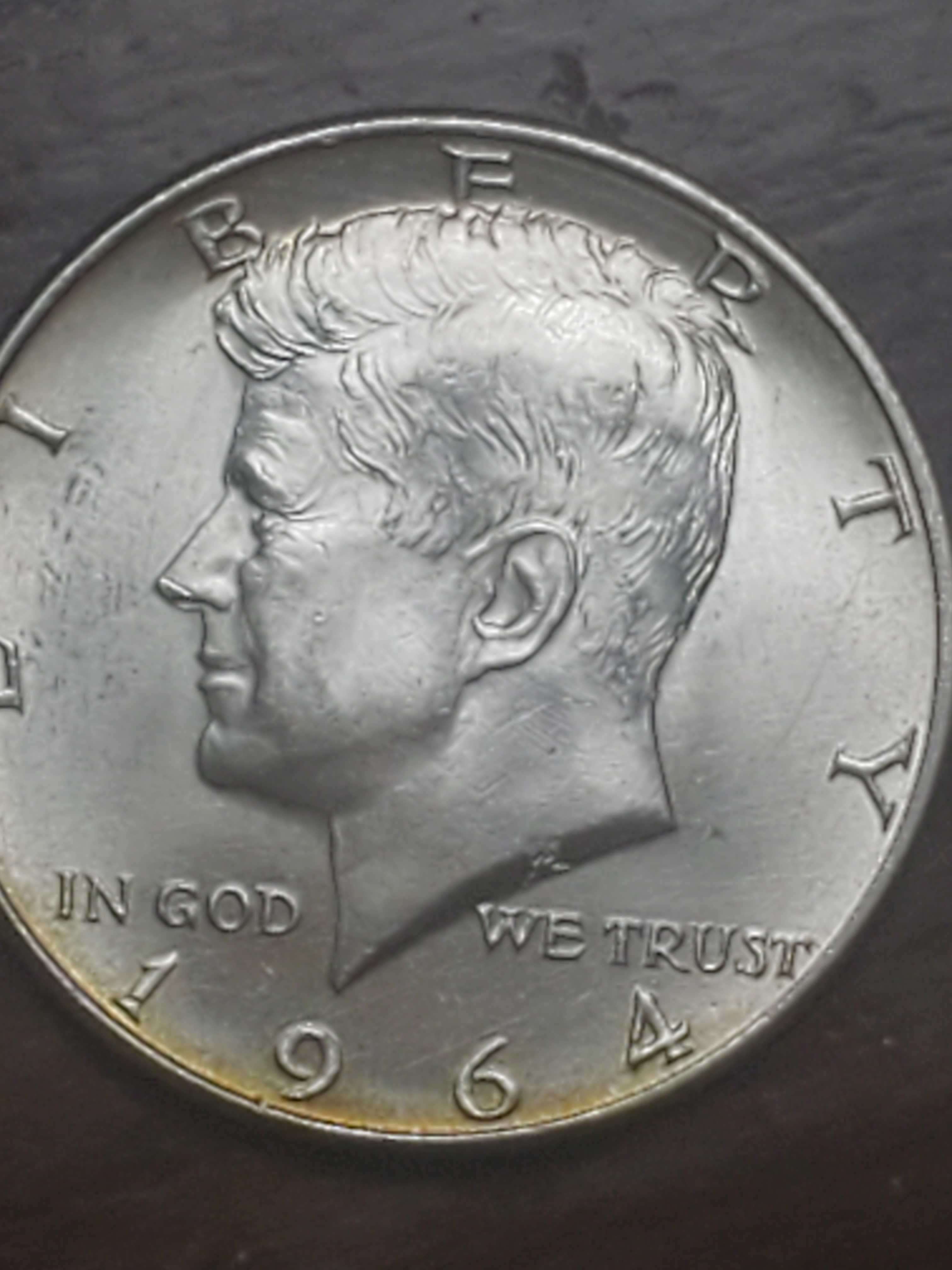 1964-Kennedy-Half-Dollar.-There-Is-An-Error-Below-The-M-In-America.--What-Is-It