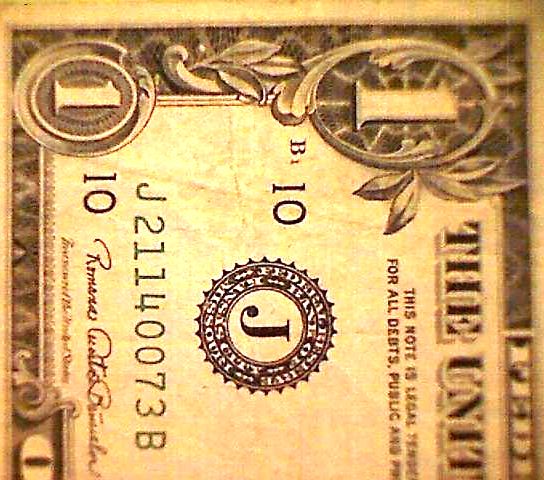 Couple-Of-$1-Bills-Behind-A-Picture-Frame