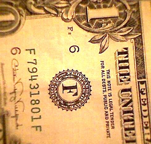 Couple-Of-$1-Bills-Behind-A-Picture-Frame