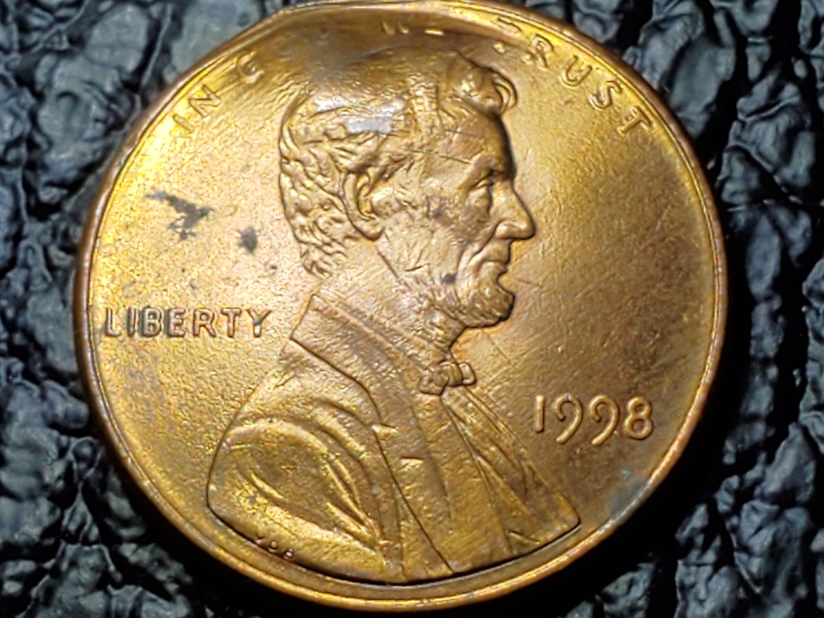 Is-This-Something-Struck-Through-This-Penny?-A-Button?