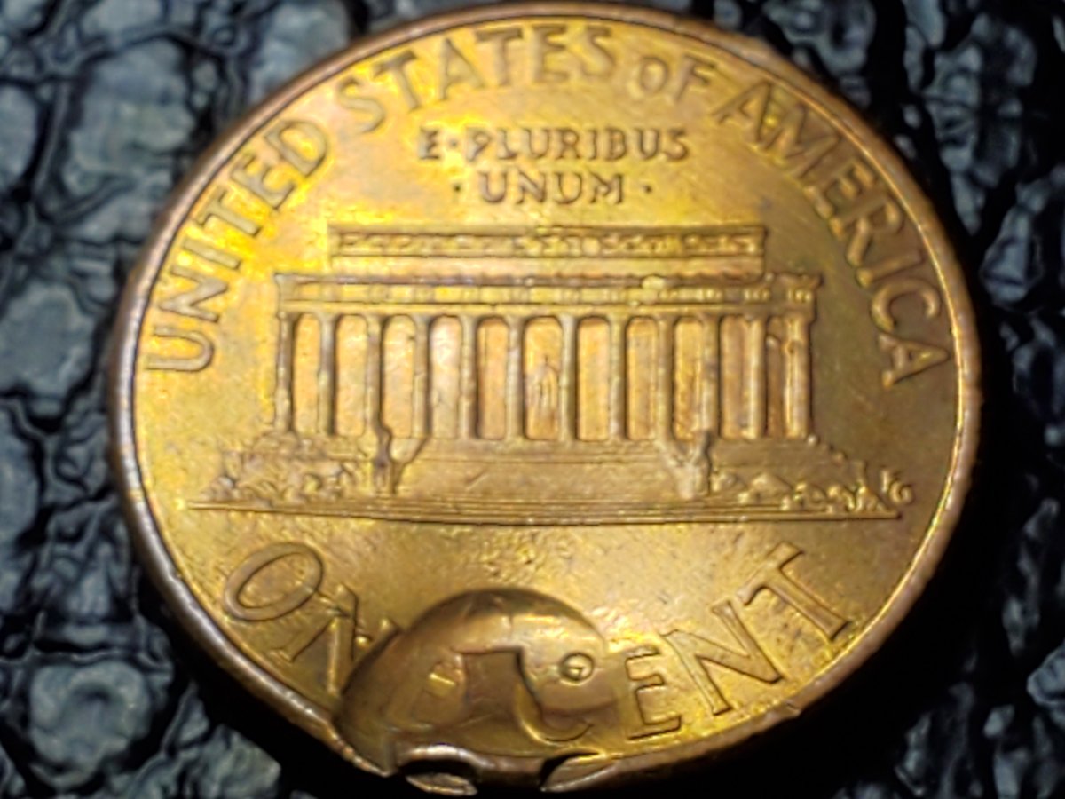 Is-This-Something-Struck-Through-This-Penny?-A-Button?