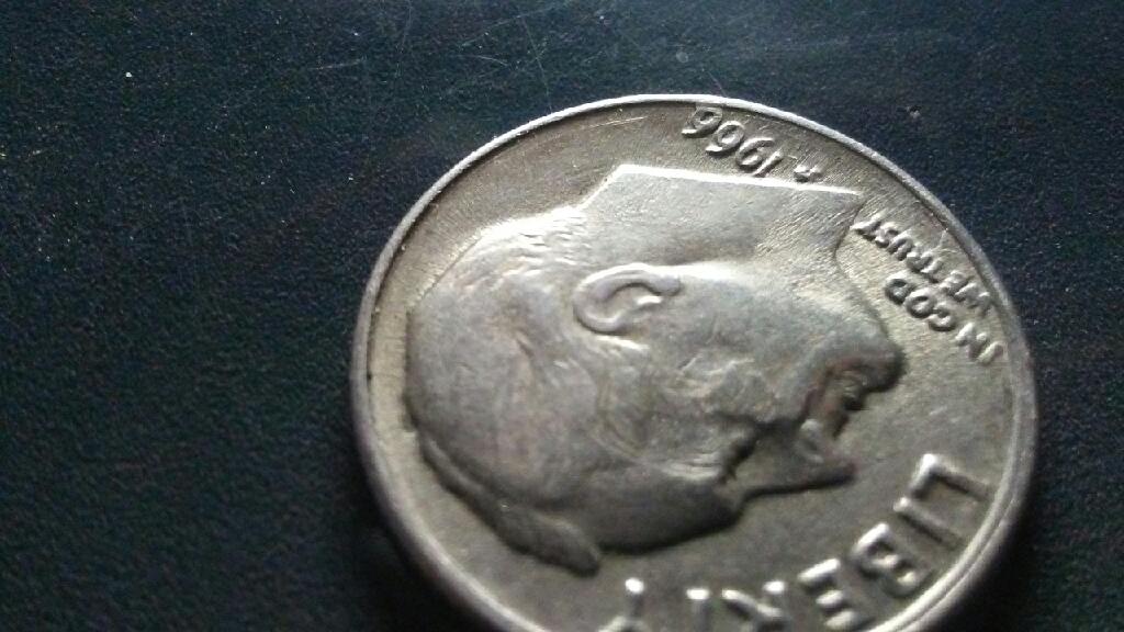 A-Smudge-Embedded-In-Presidents-Cheek-On-This-1966-Dime?
