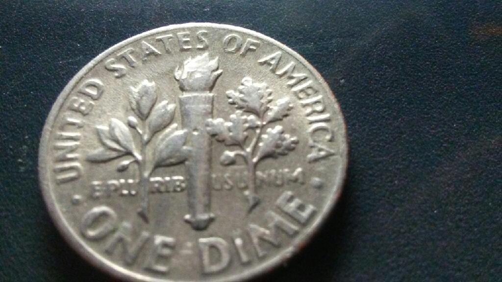 A-Smudge-Embedded-In-Presidents-Cheek-On-This-1966-Dime?