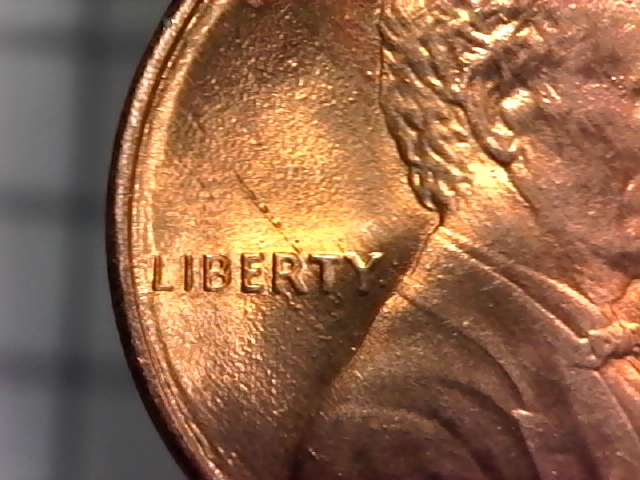 Why-Do-The-Letters-On-This-1987-D-Penny-Look-Like-They-Are-On-An-Inner-Rim?