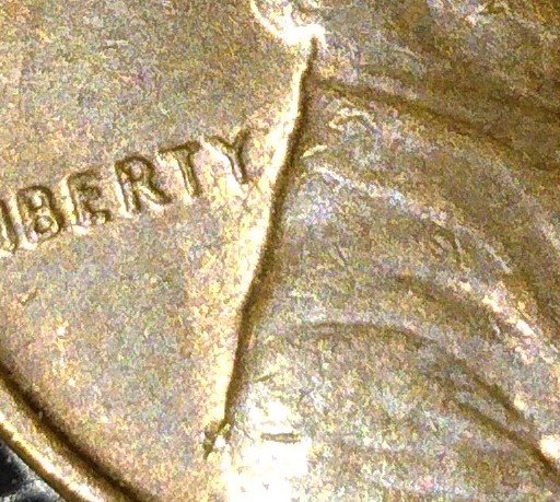 What-Is-This-Crack-Or-Line-Down-The-Back-Of-Lincolns-Neck-And-Back-On-This-1969-D-Penny?