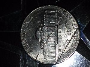 Nickel-With-Dime-Edge-Track-Marks?