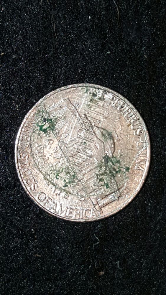 Lincoln-Cent-Stamped-On-Obverse-Side-Of-Jefferson-Nickel-While-Roll-Huntin