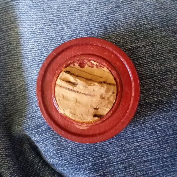 Wooden-Circular-Object-With-Man-On-The-Front