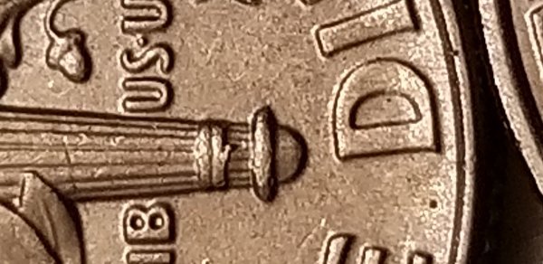 Torch-On-Back-Of-Dime-Is-Coming-Untied-At-The-Bottom.