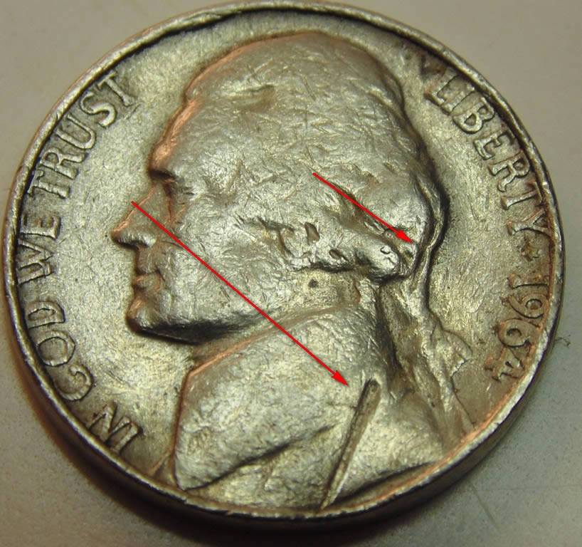 3-Nickels-With-Strange-Enough-Damage-To-Post.