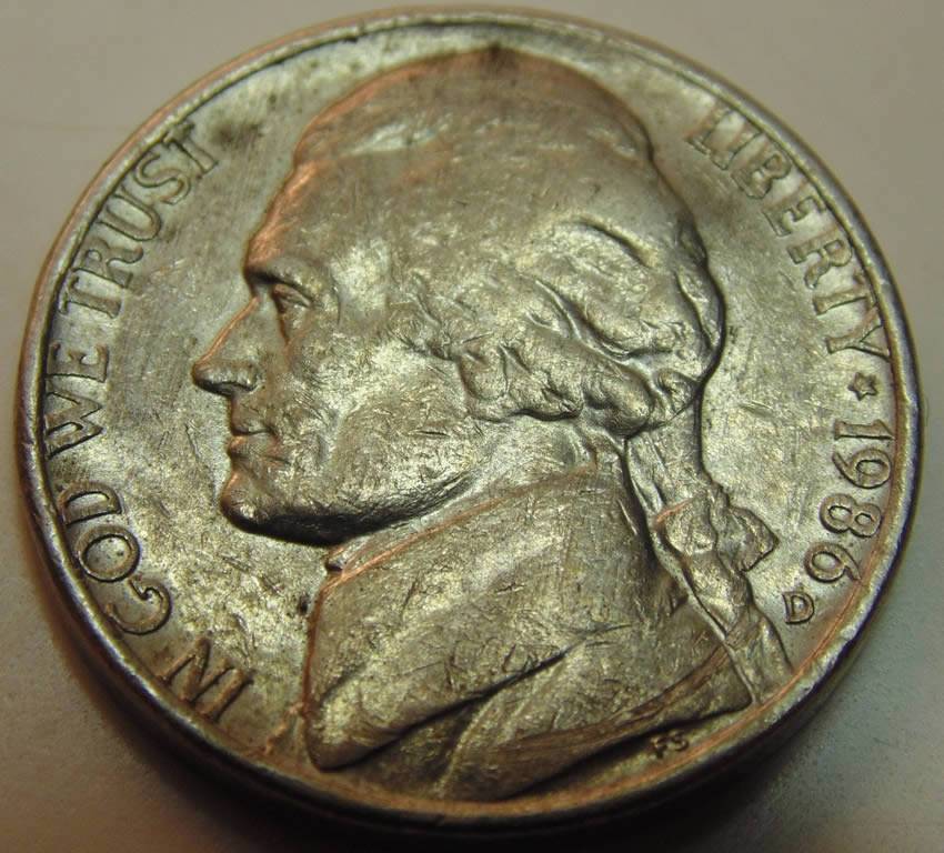 3-Nickels-With-Strange-Enough-Damage-To-Post.
