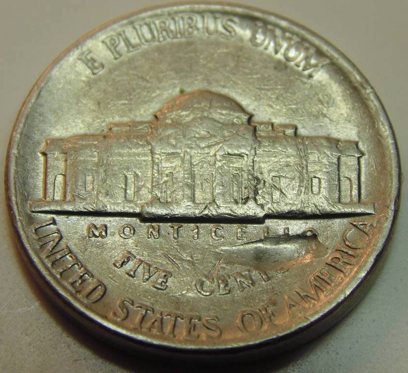 3-Nickels-With-Strange-Enough-Damage-To-Post.