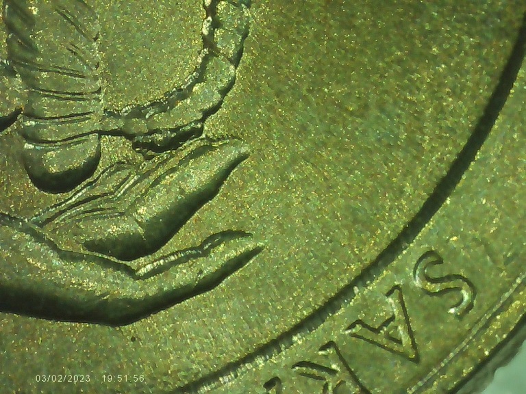2015-Quarter-With-Die-Chip-Between-Finger-&-Sword-Handle