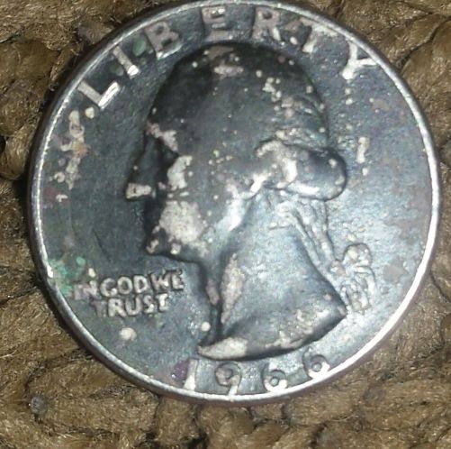 Strange-Looking-Quarter-Covered-In-Black
