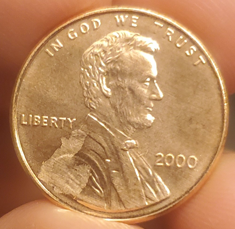 2000-P-LMC-Struck-Through-Obverse-Possible-Cloth/Paper-Strike-Through?