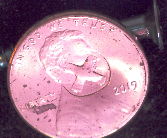 Is-This-Something-Struck-Through-This-Penny?-A-Button?