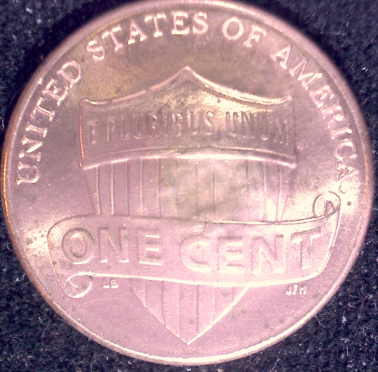 Is-This-Something-Struck-Through-This-Penny?-A-Button?