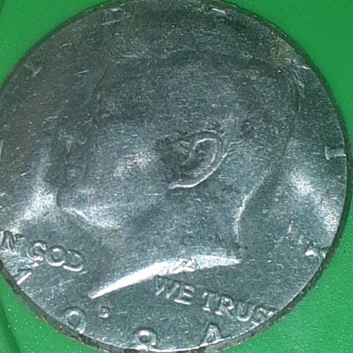 1984-Kenneddy-Half-Dollar-Is-Missing-The-Outer-Rim-Of-The-Reverse-Side