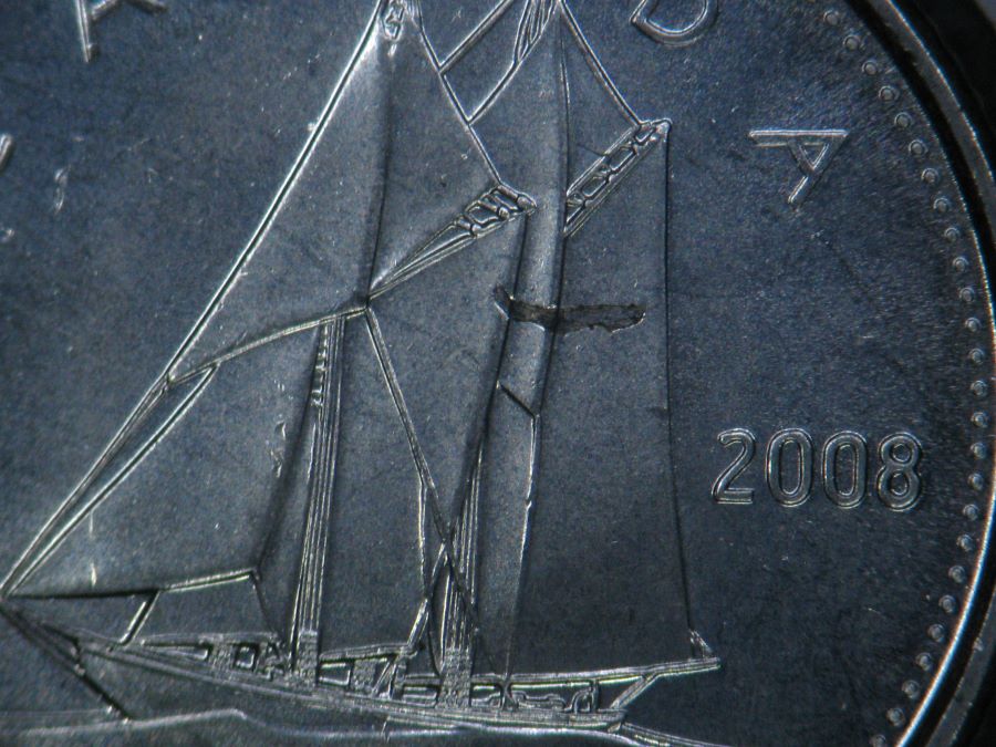 2008---10-Cent-Struck-Over-Metal-Fragment-And-Imbedded.