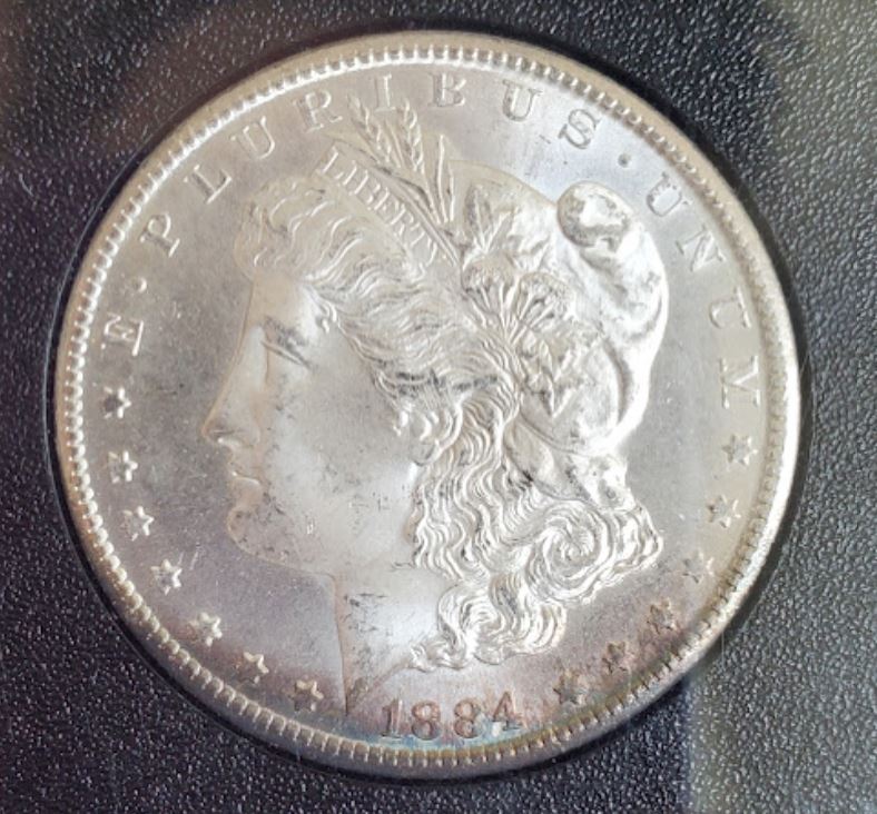 1884-CC-Morgan,-Crescent-Toning.-GSA-Holder-For-Grading.
