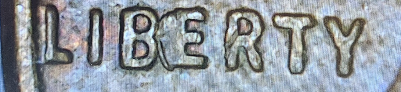 1957-Wheat-Cent-Error-On-Liberty.