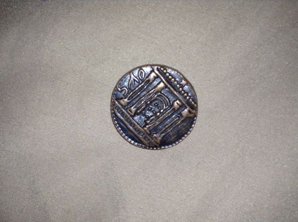 Really-Old-Weird-Coin-With-Broom-On-It