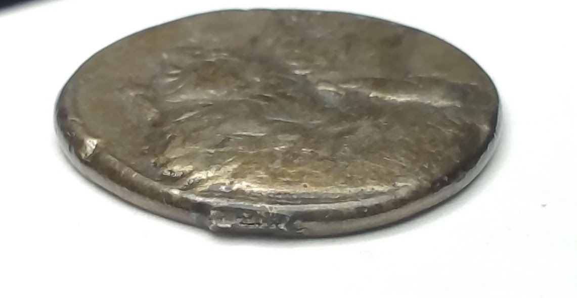 Coin:-One-Side-Mans-Head-/-Other-Side-Lions-Head