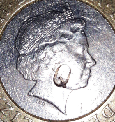 Q-Stamped-On-Both-Sides-Of-A-�2-Coin.