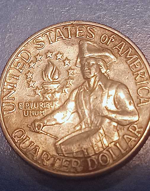 Bicentennial-Quarter-With-No-Mint-Mark-That-Almost-Appears-To-Be-Printed-Over-A-Used-Planchette