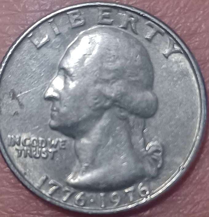 Bicentennial-Quarter-With-No-Mint-Mark-That-Almost-Appears-To-Be-Printed-Over-A-Used-Planchette