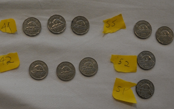 Piles-Of-Old-Nickels-And-Pennies