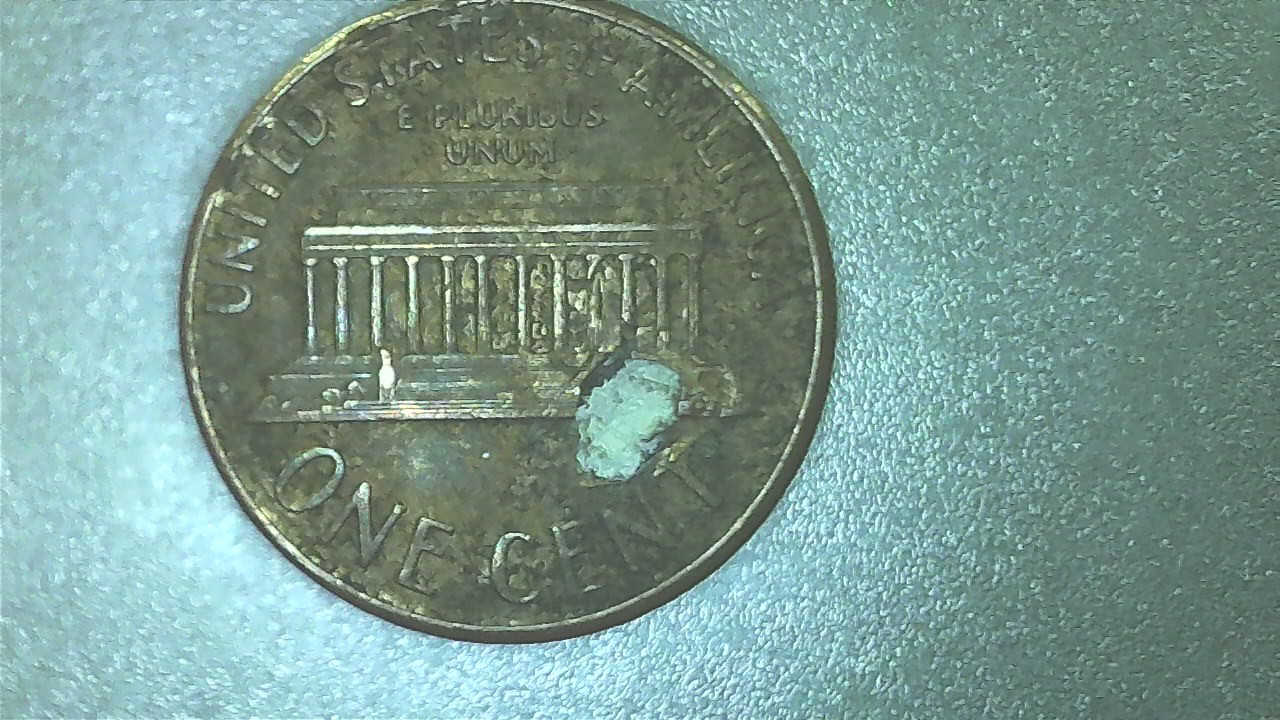 1989-No-Mint-Lincoln-Cent-W/-Remnants-Of-Unknown-Object-In-Face