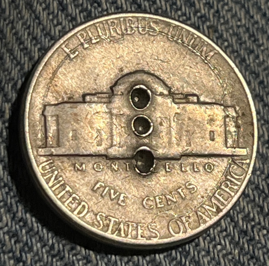 1952-P-Jefferson-Nickle.-The-Shape-Of-The-Ring-Around-The-Three-Holes-Is-?-Damage-From-?