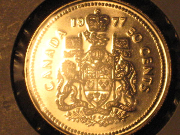 Five-Unc/Pl-50-Cent-Pieces,-Confused-About-Grades
