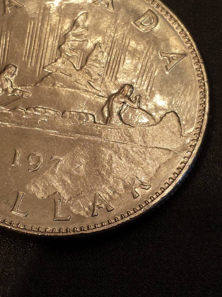 197?-1-Dollar-Struck-Through-Or-Planchet-Flaw?