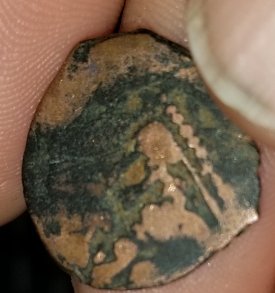 Weird-Coin-With-A-Bow-And-Letters-Inside