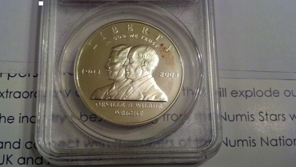 Strange-Spot-On-2003-First-Flight-Comm-Silver-Dollar