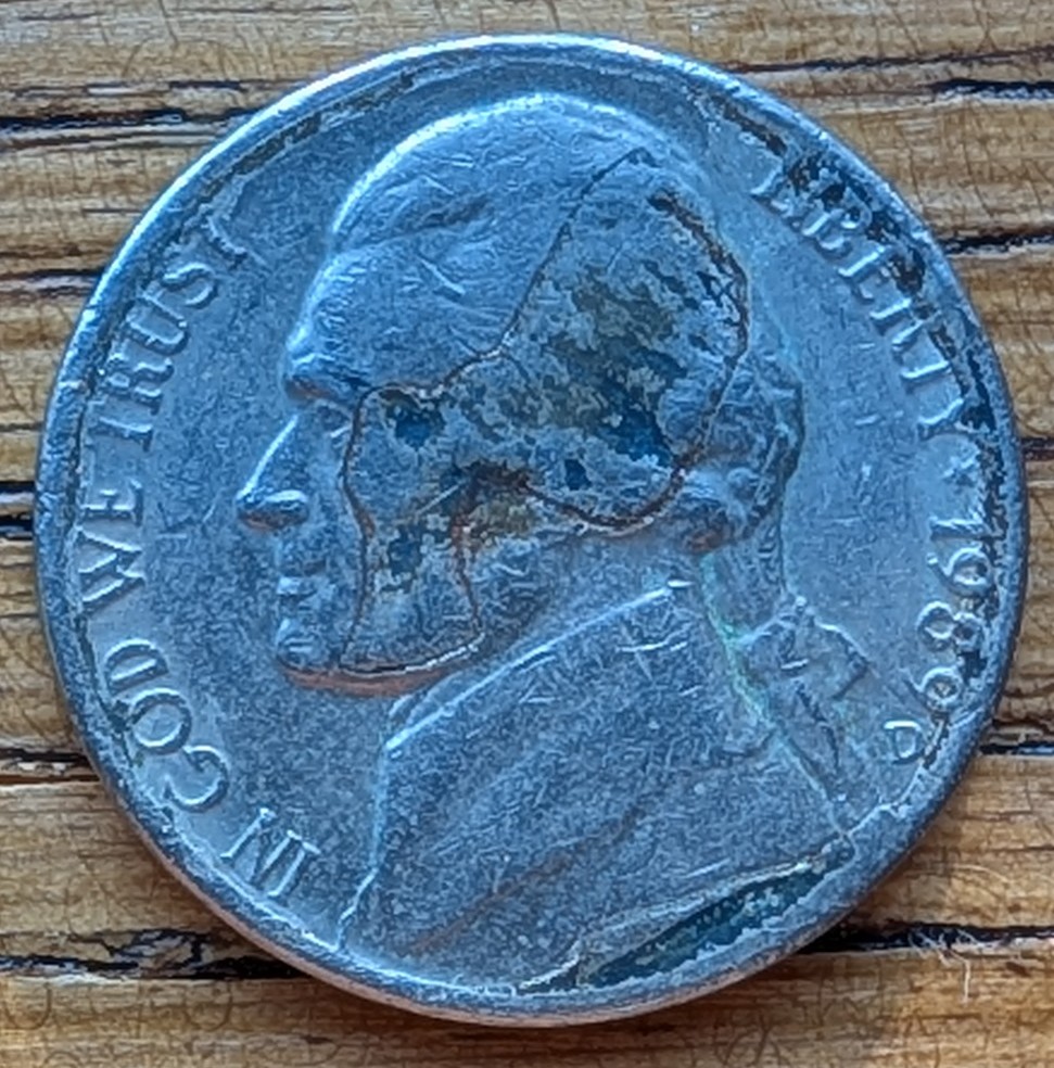 Jefferson-Nickel-Struck-In-Metal-Fragment