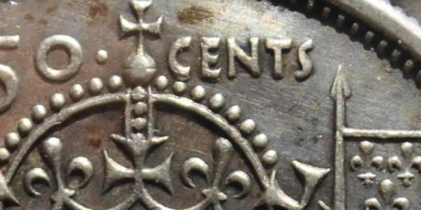 1957-50-Cents-With-Extra-Metal-On-5-In-Date