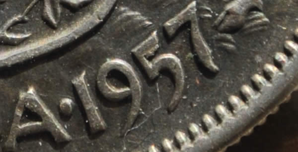 1957-50-Cents-With-Extra-Metal-On-5-In-Date