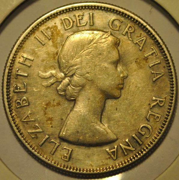 1957-50-Cents-With-Extra-Metal-On-5-In-Date