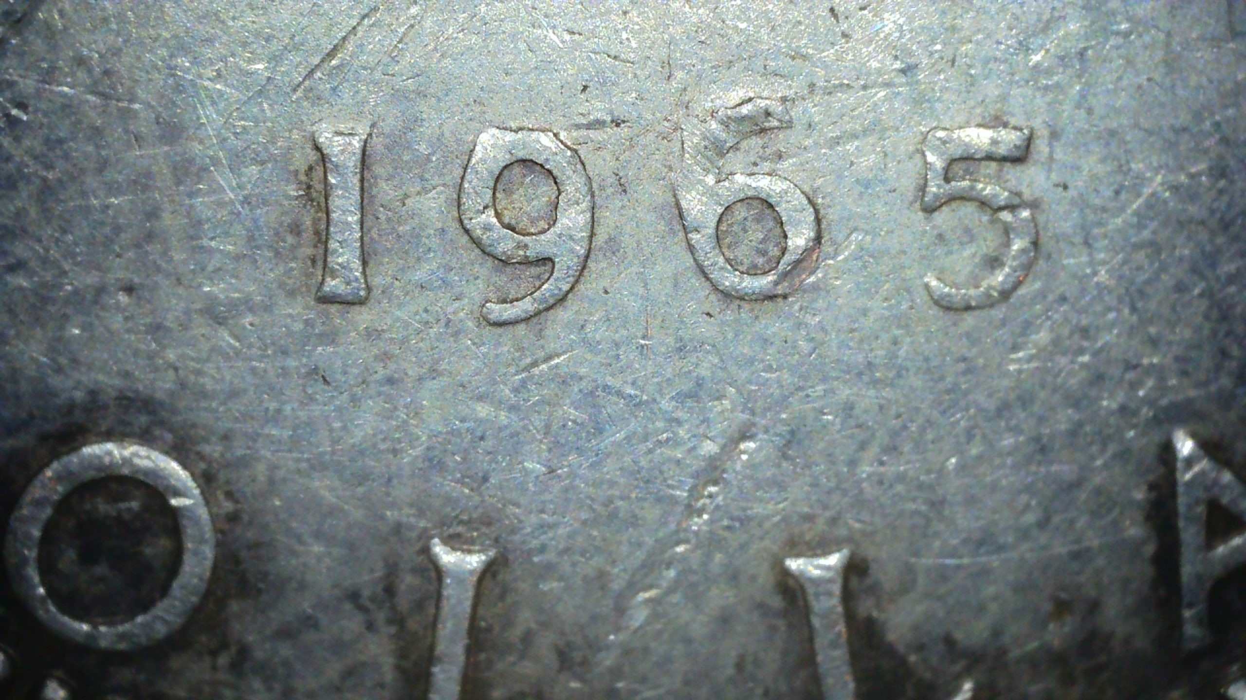 1965-Silver-Dollar---'6'-At-Odd-Angle.-Seeking-Information