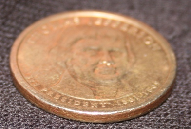Circulated-Jefferson-Dollar-Missing-Edge-Letters---Fake?