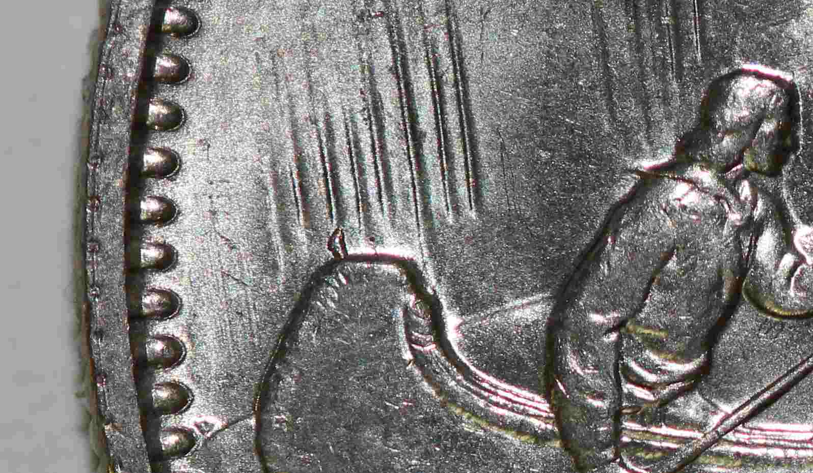 1969-Dollar-With-Feather?-Sticking-Up-From-Back-Of-Canoe.